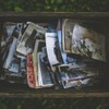 A nostalgic collection of vintage photos in an old wooden box.